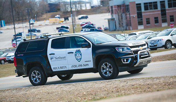 Campus security vehicle driving around campus