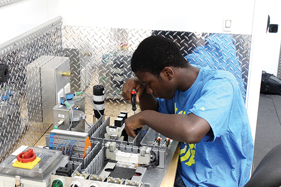 A middle school student works in the mobile CIM lab